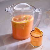 Clear, BPA-free pitcher filled with orange lemonade next to a glass with a sugared rim on a light background.
