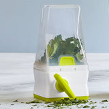 Herb keeper with fresh herbs on a light wooden surface.