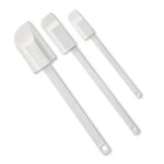 Set of three white kitchen scraper spatulas on a white background.