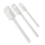 Set of three white kitchen scraper spatulas on a white background.