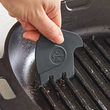 Close-up of a grill pan and grill scraper.