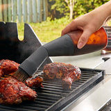 Person using flexible grill basting on food outdoors.