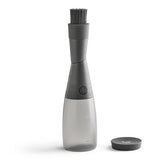 Gray kitchen basting brush on bottle attachment on a white background