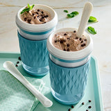 Two blue textured containers with chocolate chip ice cream on a light green tray.