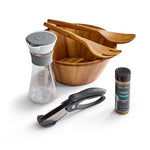 Set of kitchen tools including a wooden bowl with utensils, salad dressing container, a knife, and spice jar on a white background.