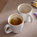 2-Piece Mug Set with one containing tea and teabag.