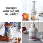 White kitchen food chopper being utilized to chop various ingredients on a kitchen countertop.