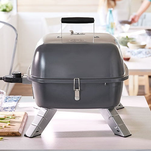 Portable grill on a table with a blurred background