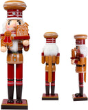 Three nutcrackers in a row, each with a different pose and expression, on a white background.