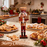 Decorative nutcracker figure on a kitchen counter with Christmas cookies and buns, surrounded by festive decorations.