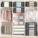 Closet organization system with hanging clothes, folded items, and storage boxes.