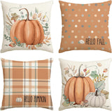Four decorative pillows with autumn-themed designs featuring pumpkins and polka dots.