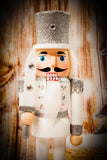 Decorative nutcracker figure with a wooden background