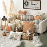 Cozy living room with autumn-themed decor, including pillows and pumpkins.