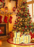 Decorated Christmas tree with lights and ornaments in a living room with a fireplace and stockings.