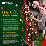 Christmas ornament with angel wings design, featuring a man and child near a decorated tree.