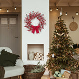 Living room decorated for Christmas with a wreath, tree, and presents.