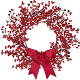Decorative wreath with red berries and a red bow on a white background