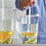 Two clear pitchers filled with water and fruit on a countertop.