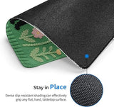Textured black mouse pad with green fabric edge and floral pattern, showing grip text.