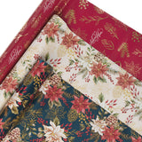 Three rolls of floral and nature-themed wrapping paper.
