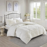 White, cotton bedding duvet cover and pillow shams displayed with nightstands on either side of bed with black iron headboard.