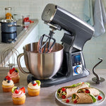 Deluxe Electric Stand Mixer on kitchen counter with food, including cupcakes.
