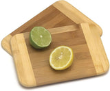 Wooden cutting board with sliced lemon and lime on a white background