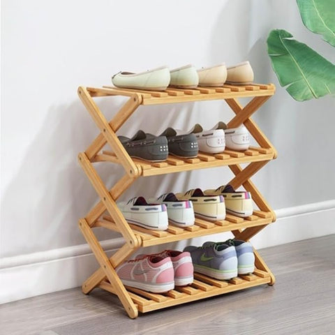 Wooden shoe rack with shoes on a light wooden floor against a white wall.
