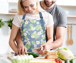 Light blue and green floral apron with wide pocket and adjustable straps.
