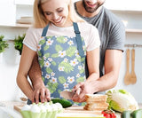 Light blue and green floral apron with wide pocket and adjustable straps.