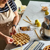 Person making pasta on a stoneware pie plate with kitchen tools and ingredients.