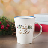 Ceramic drinking mug with "Feliz Navidad" inscribed in gold color.
