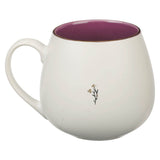 White mug with purple interior and floral design on a white background