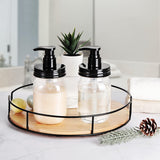 Two BPA-free, plastic bottles with black pump tops on a round wooden tray in a bathroom setting.