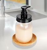 BPA-free, plastic soap dispenser with black pump on a wooden coaster on a kitchen counter.