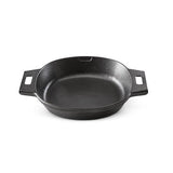 Black cast iron skillet on a white background.