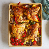 Roasted chicken with vegetables on a Natural Clay Rectangular Baking Tray.