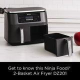 Ninja Foodi 2-basket Air Fryer DZ201 on a kitchen counter with an apple in the background.