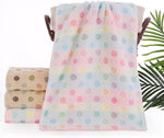 Set of colorful polka dot towels with a leafy background