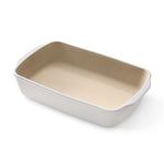 Rectangular stoneware baking and serving dish with beige interior and white exterior on a white background.