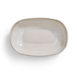 Natural, ceramic rectangular serving dish on a white background.