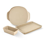 Set of beige, stoneware baking dishes on a white background.