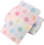 Two folded towels with colorful polka dot patterns on a white background
