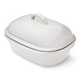 White satin glazed stoneware covered baking dish with lid on a white background.