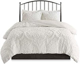 White textured comforter set on a black metal bed frame with white pillows.